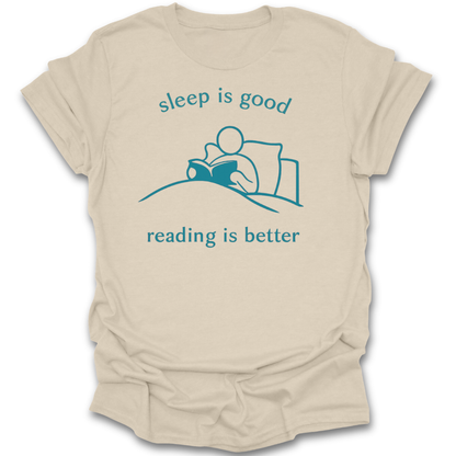 Beige t-shirt with blue graphic and text 'sleep is good, reading is better' on a white background book t shirt