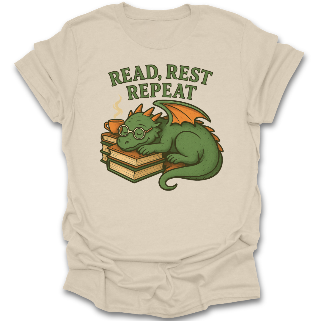 Beige t-shirt with a dragon graphic and 'Read, Rest Repeat' text on a white background fantasy book reading literary t shirt