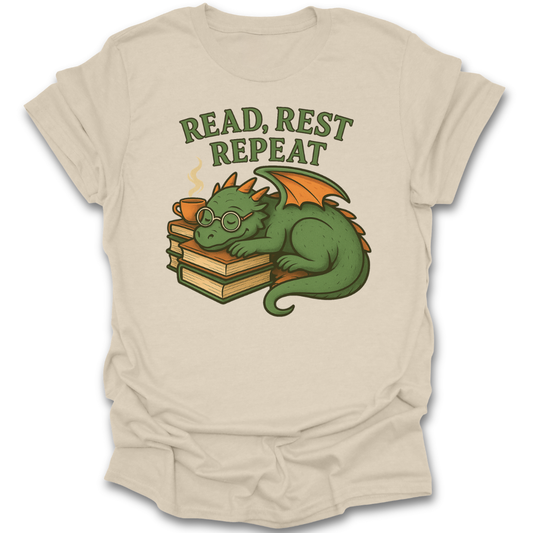 Beige t-shirt with a dragon graphic and 'Read, Rest Repeat' text on a white background fantasy book reading literary t shirt