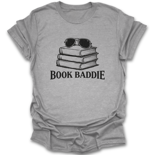 Gray t-shirt with 'Book Baddie' graphic and stack of books and sunglasses on a white background funny book reading literary t shirt
