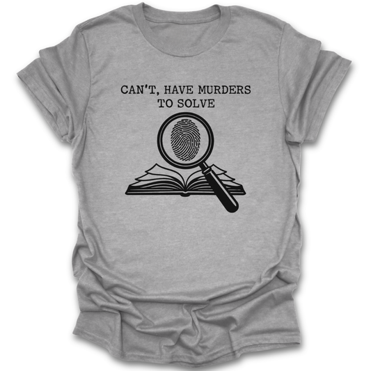 Gray t-shirt with black graphic and text 'Can't, have murders to solve' on a white background true crime thriller mystery funny book reading literary t shirt