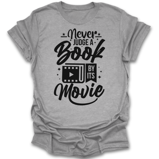 Gray t-shirt with black text 'Never Judge a Book by Its Movie' on a white background funny book reading literary t shirt